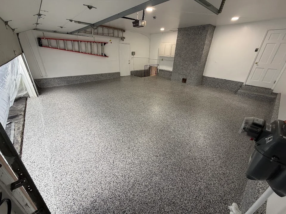 Spartan garage floor with a gray speckled coating and matching perimeter details